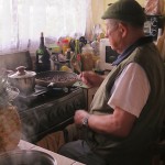 Papa toasting Cacao to make chocolate.